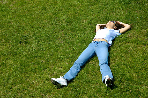 istock Happy young woman lying in grass summer scenic 90395621