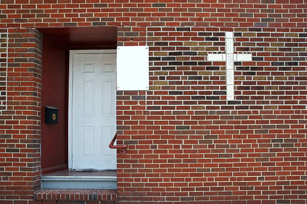 Industrial orange brown metal double swinging closed door in red brick wall. Background replacement
