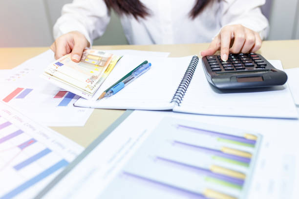 istock Businesswoman check profit document and calculate about and note data cost at home 903956848