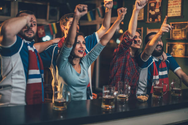 istock Fans celebrating victory at the bar 903957412