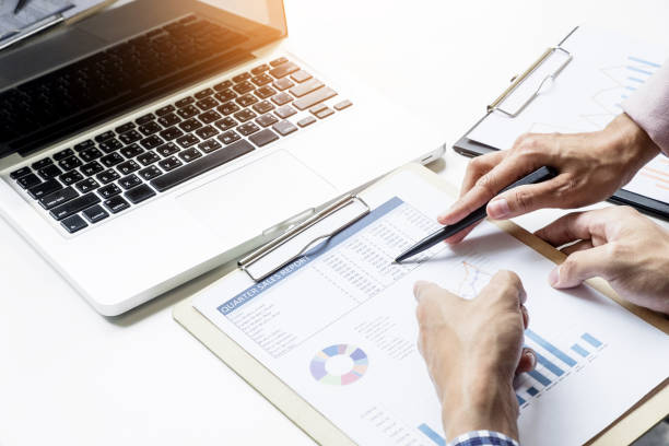istock Business People Discussing Over Document At Table In Office 903960478