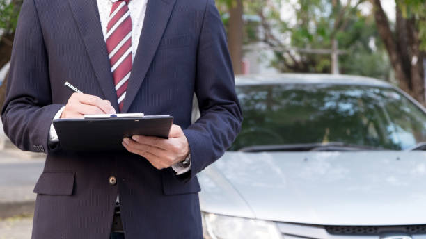 istock Midsection Of Businessman Holding Clipboard While Standing By Car 903960528