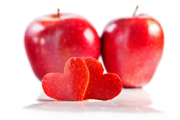 istock Two red hearts are cut out from apple, two red apples on a background 903964638