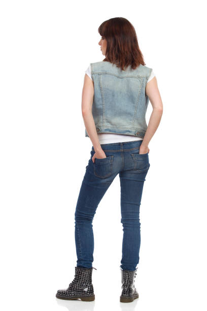 istock Young Relaxed Woman Is Standing And Looking Away. Rear View. 903964706