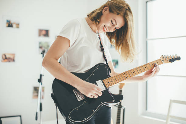 istock Blond girl guitarist 903968490