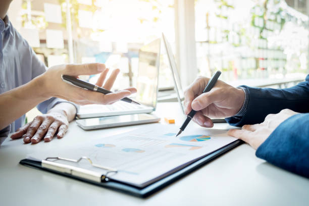 istock Midsection Of Business People Working At Table In Office 903968886