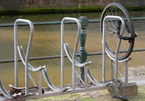 A large number of bicycles parked in provided racks near to the main entrance of Copenhagen's central train station.