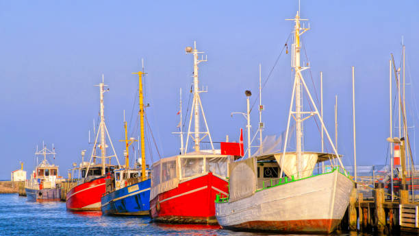 istock Boats Moored At Harbor Against Clear Blue Sky 903971748