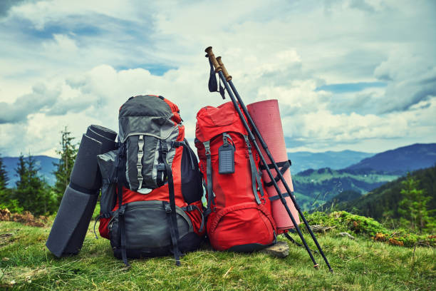 istock Backpacks in the mountains overlooking the mountains on the green grass. 903972948