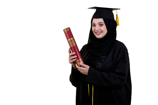 education, graduation and people concept - muslim woman in hijab with diploma over white background.