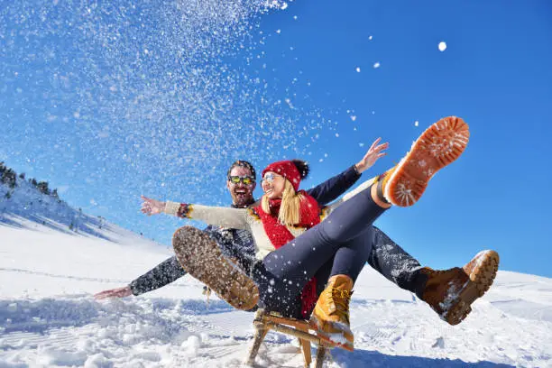 romantic winter scene, happy young couple having fun on fresh show on winter vacatio, mountain nature landscape.