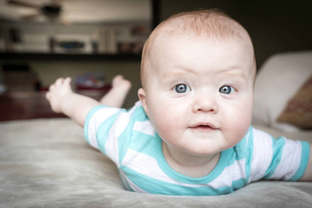 istock Beautiful Happy Baby Boy Playing On Bed 903989690