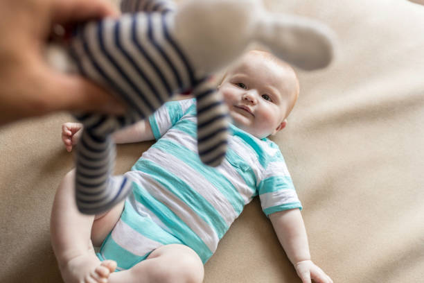 istock POV Dad Playing with baby Boy and Plush on Bed 903989696