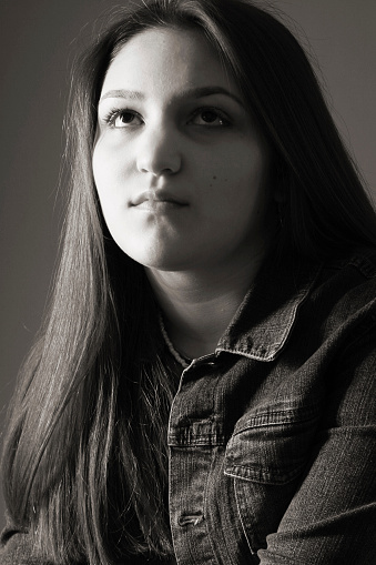 Black and white photo of a teenage girl with thoughts on her mind