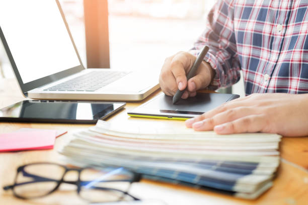 istock Midsection Of Man Working On Graphics Tablet At Desk In Office 903996116