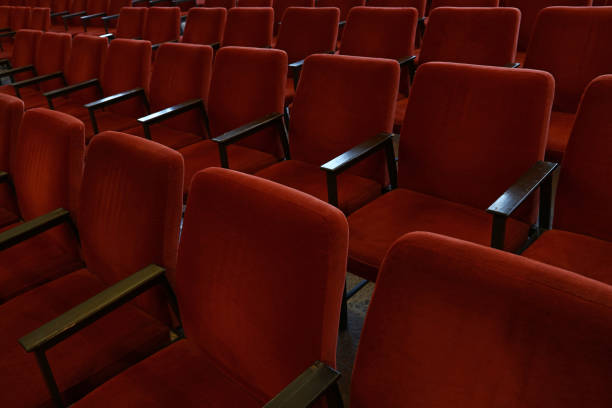 istock Empty Red Chairs In Row At Theater 903996860
