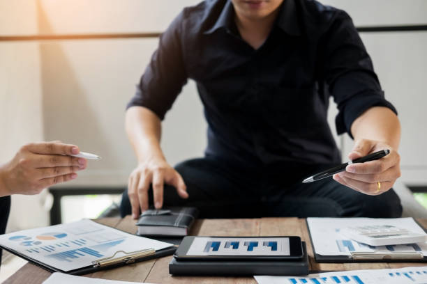 istock Midsection Of Business People Working At Table 903999660