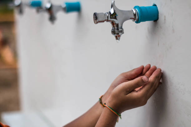 istock Close-Up Of Human Hand At Drinking Fountain On Wall 903999998