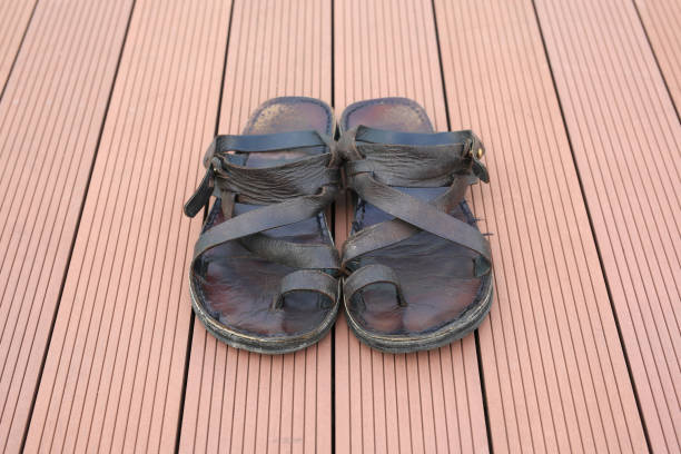 istock Mens summer brown leather sandals on wood plank background. 904000116