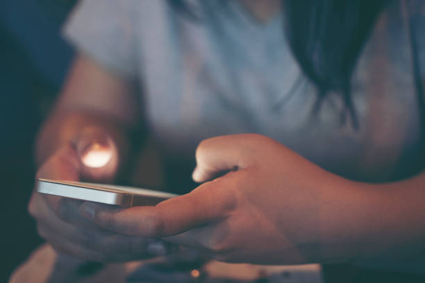 istock Midsection Of Woman Using Phone In Darkroom 904000956