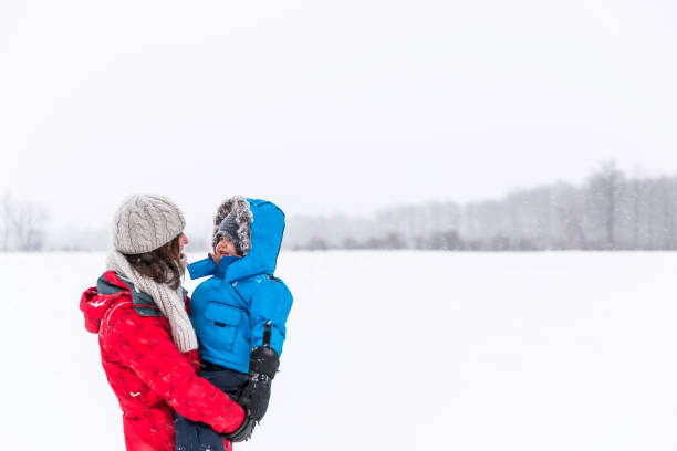istock Mother and Son in Winter Forest Snowstorm 904003476