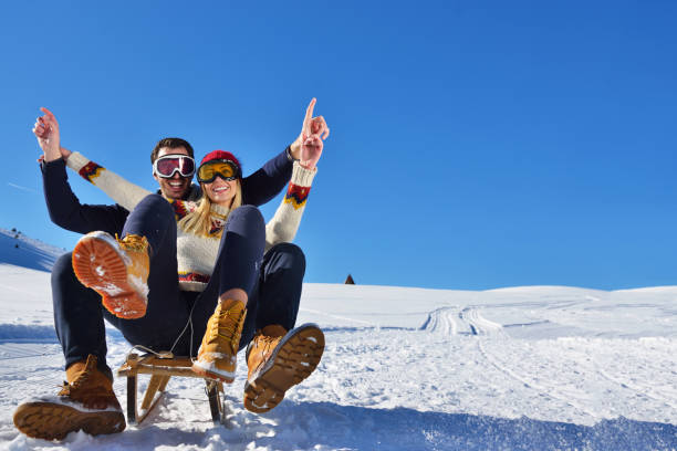 istock Young Couple Sledding And Enjoying On Sunny Winter Day 904003992