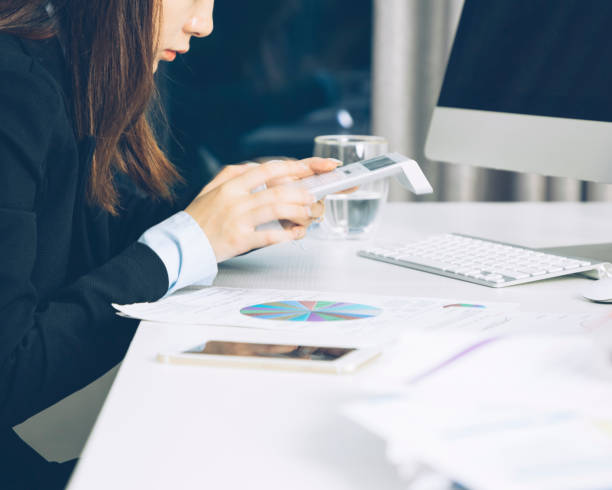 istock Midsection of woman working on calculator 904004856
