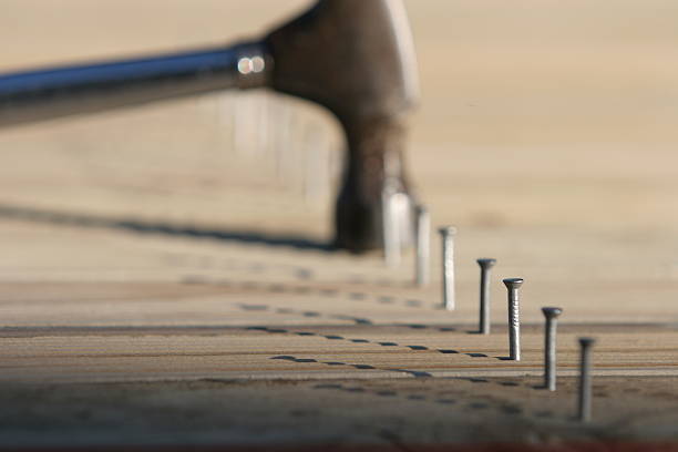 Line of nails and hammer stock photo