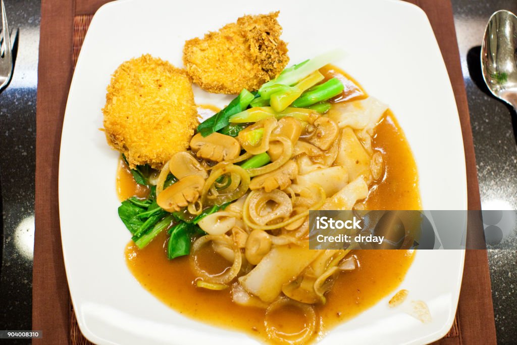 Noodle with fried chicken Noodle in soy sauce with mushroom amd fried chiken. Local Thai street food. Chinese Food Stock Photo