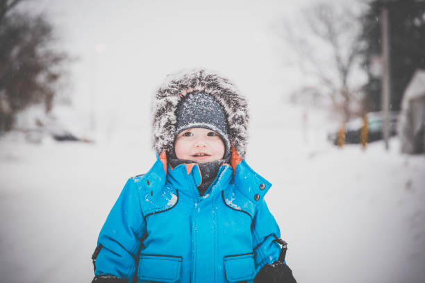 istock Little Boy in Blue Winter Clothes Having Fun With Snow 904008574