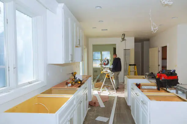 Photo of Contractor Using Circular Saw Cutting Crown Moulding for Renovation.