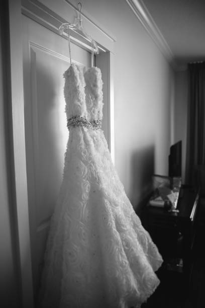 istock Wedding Dress Hanging on a door 904008648