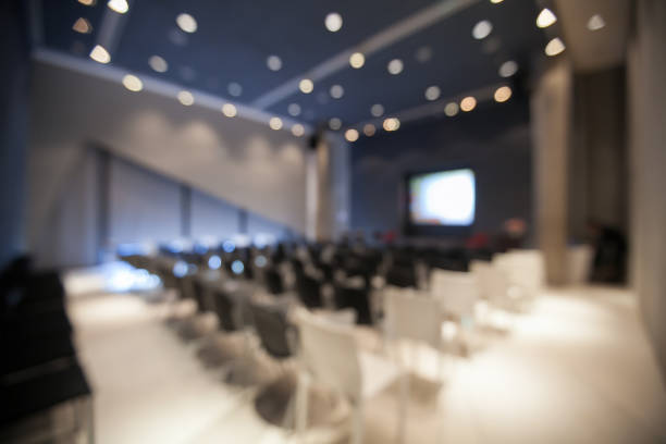 istock blurry background of seminar room empty with bokeh of ceiling light. 904008706