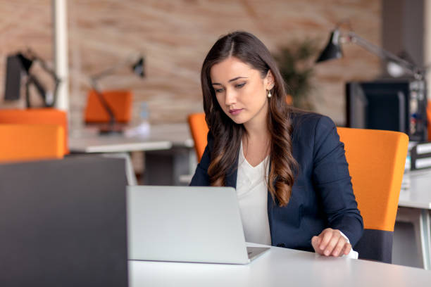 istock Young businesswoman using laptop at office table 904010950