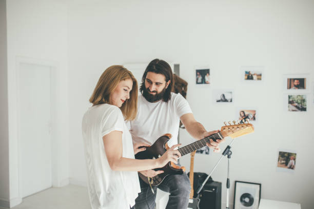 istock Girl on guitar lesson 904011032