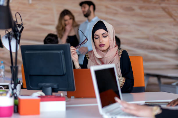 istock Attractive Muslim young woman working in office on computer 904015700