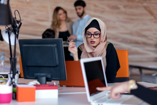 istock Attractive Muslim young woman working in office on computer 904015922