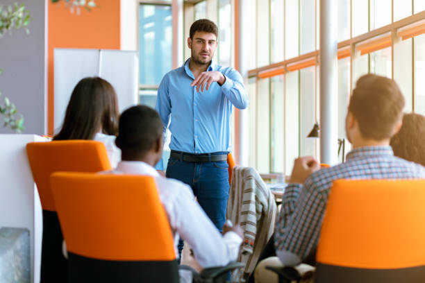 business, startup, presentation, strategy and people concept - man making presentation to creative team at office