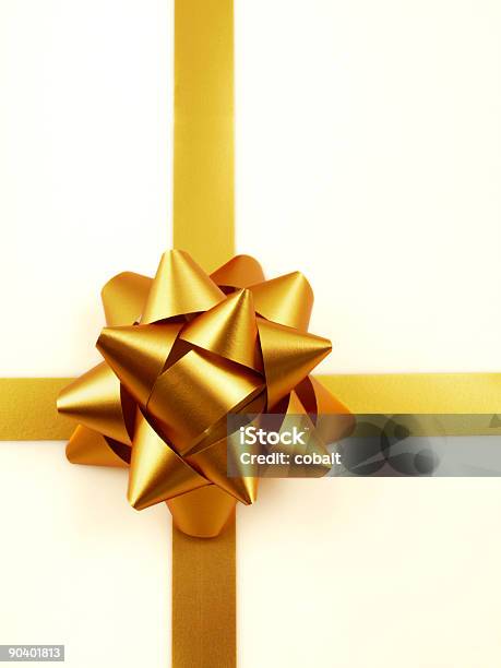 Golden Bow And Ribbon On Cream Wrapping Paper Stock Photo - Download Image Now - Box - Container, Christmas, Christmas Present
