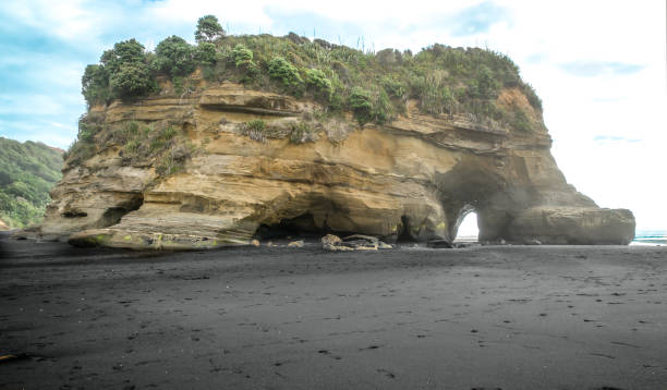 istock Huge mudstone rock monolith on three sisters black volcanic beach 904025216