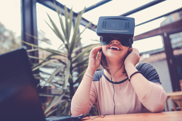 istock Young Woman Having Fun with Virtual Reality Simulator and Gesturing 904025234