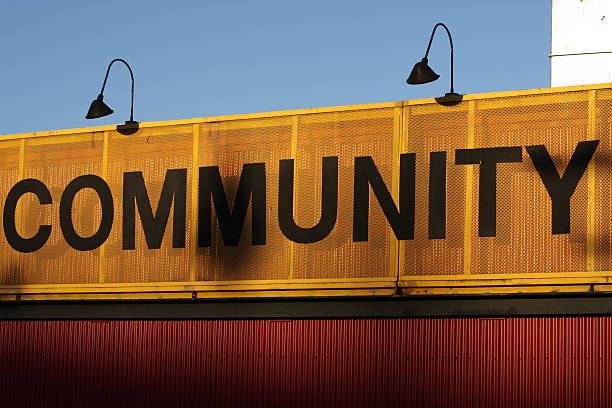 A community centre with clear signage. Black letters on an orange backdrop.