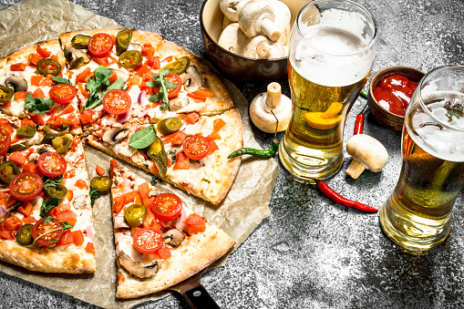 Mexican pizza with cold beer. On a rustic background.