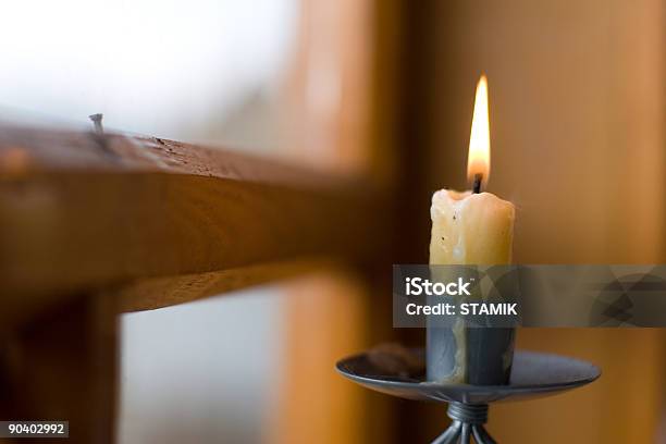 A Lighted Candle Stick Near A Window Stock Photo - Download Image Now - Window, Candle, Atmospheric Mood
