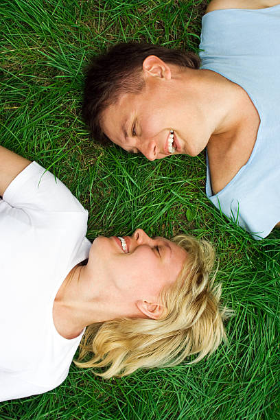 istock man and woman lie on grass 90403208