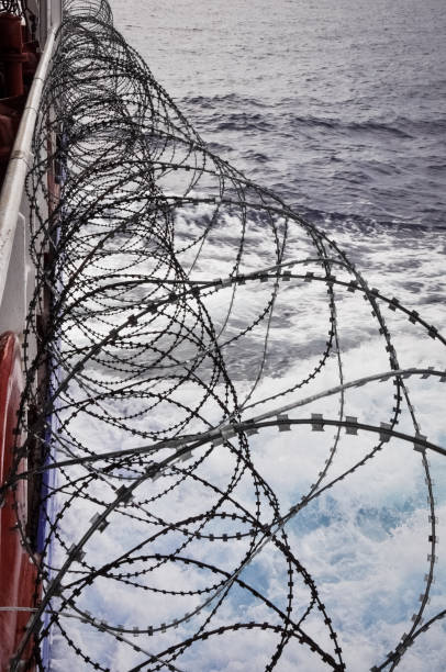 istock Barbed wire onboard of a shp passing pirats area 904032514