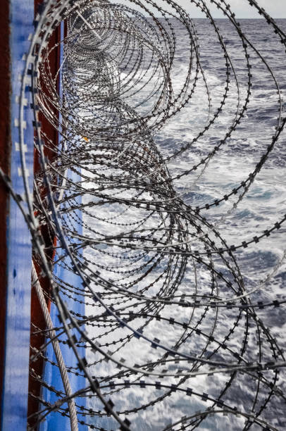 istock Barbed wire onboard of a shp passing pirats area 904032584