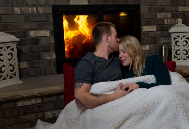 istock Young couple snuggling at home 904032970