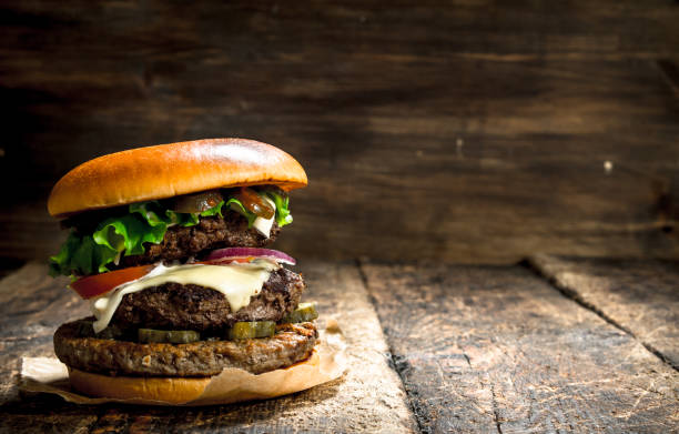 istock Big burger with beef, tomatoes and greens. 904033180