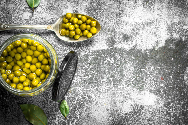 istock Marinated green peas in glass jar. 904033280